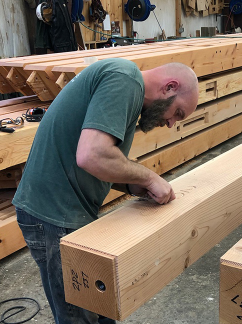 One finishing touch to the LNB timber frame includes a custom carving, commemorating the year the project will be raised, applied by the skilled hands of Jake, one of our long-time craftsmen and project champion.