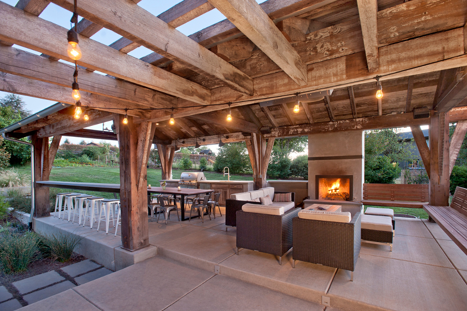 As-found industrial timbers celebrate original surfaces for this Washington family’s outdoor living space.