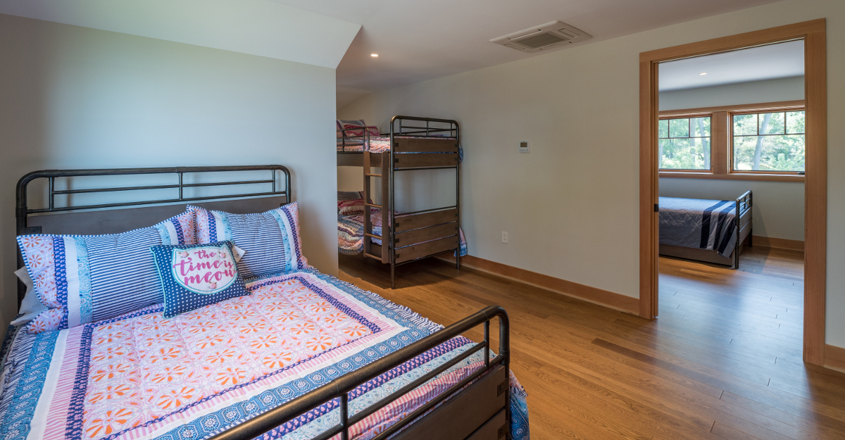 Near 5,000 sq ft total, the home includes bunk rooms over the garage, two guest rooms, the master suite, and one guest suite all meant to comfortably accommodate many for long weekends at the lake. Photo (c) Scott Hemenway