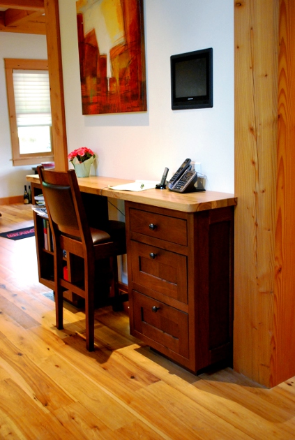 Located against a narrow wall that helps define the kitchen from the dining room, this is a desk style command center.