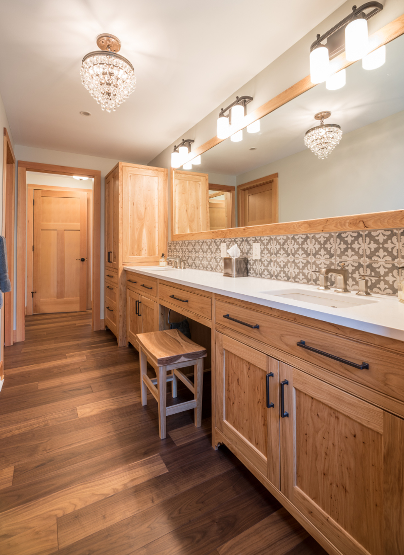 Hickory, rampant with an almost burled grain, was selectively incorporated throughout the master bath double vanity and cabinetry as well as the master closet built-ins.