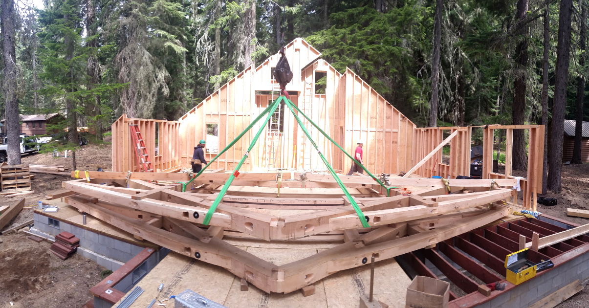 Timber bents are pre-assembled on-site, stacked on the deck and ready to be raised for the Odell Lake cabin.