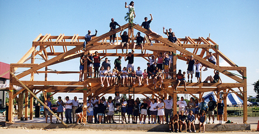 Back in 1997, with slightly fewer crew members, we raised the frame for our office in Farmington NY. We connected it to an old bowling alley which we converted into our mill and shop. Reuse: we live it and love it!