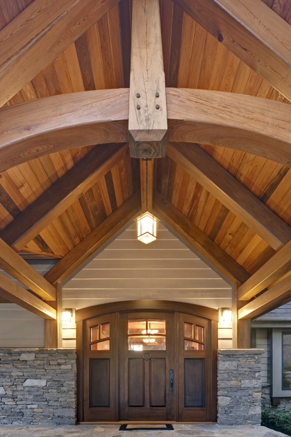 This LEED H timber frame home in North Carolina welcomes family and visitors through a reclaimed sinker cypress main entry porch.