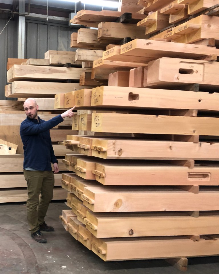 Like a big puzzle! A large stack of Douglas fir timbers for the LNB Farmington branch dwarf Bryan, project lead engineer, as he explains the end codes appearing on each stick.