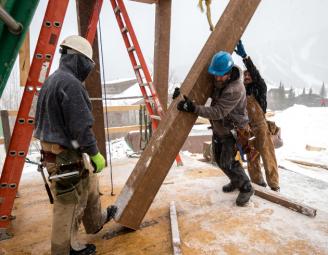 jake_lifting_timber_post_stowe_vermont.jpg