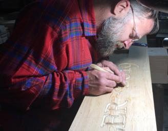 mike_w_carving_in_shop.jpg