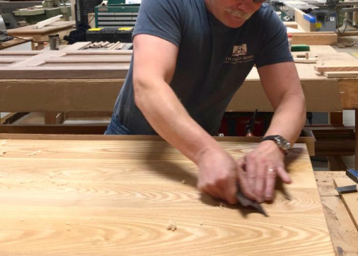 charlie_hand_scraping_joints_custom_table.jpg